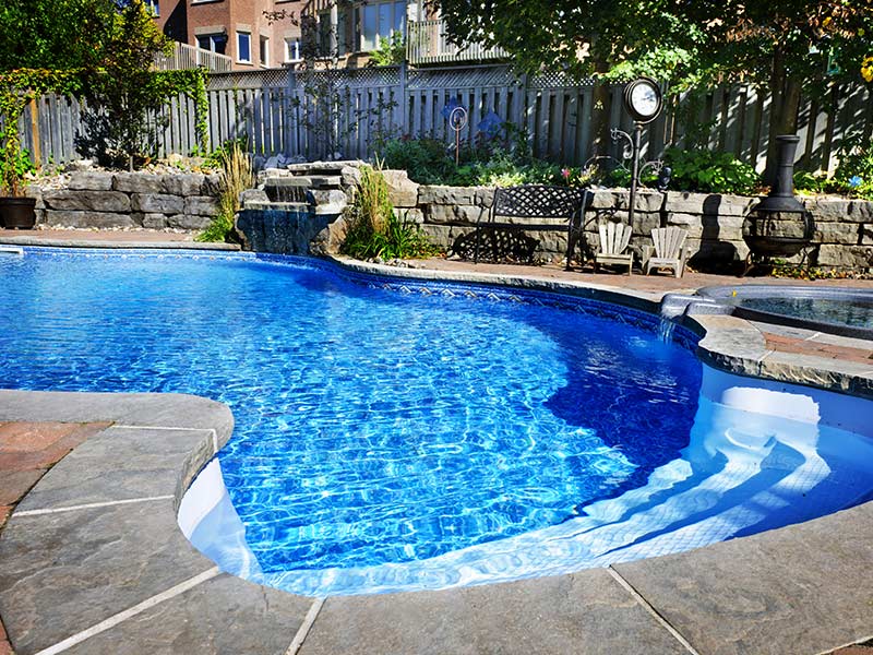 pool in backyard with stone landscaping mosel ms